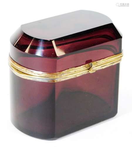 An early 20thC amethyst coloured glass casket, of oblong form, with hinged lid, metal mounts and