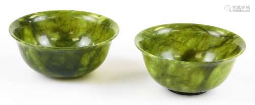 Two 20thC Chinese green hardstone bowls, of plain circular form with natural veined finish