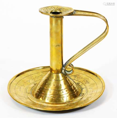 An 18thC brass candlestick, with cylindrical stem, shaped handle and circular plate base,