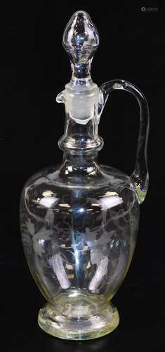 A 19thC glass decanter, with shaped stopper, moulded lip and plain handle, the bulbous body etched