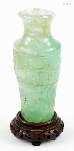 A Chinese green quartz vase, of shouldered circular form, carved with a band of flowers and marine