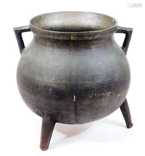 An 18thC bronze tripod cauldron, of globular form with angular handles, on three taper legs, 34cm