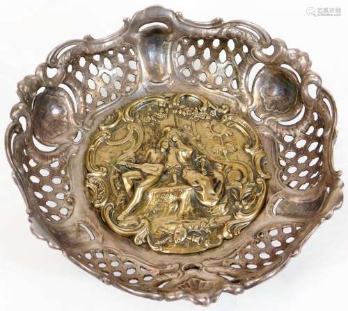 A late 19thC continental white and gilt metal bowl, the central plaque embossed with courting
