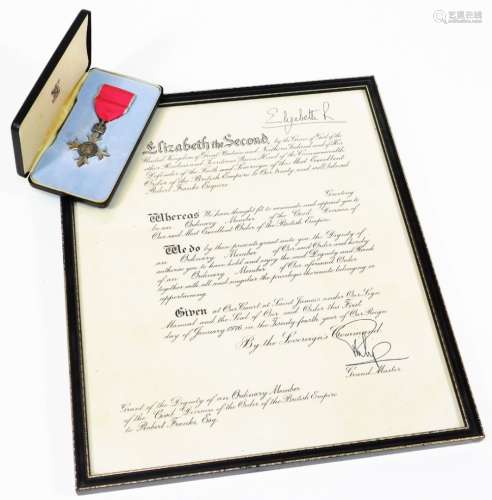 A Member Of The British Empire (MBE) medal, cased with ribbon and accompanied by dignity grant