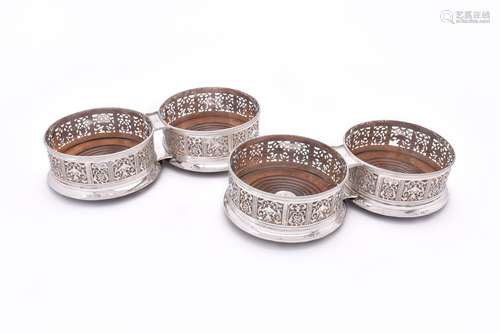 A set of four George IV silver circular coasters by Sebastian Crespel II