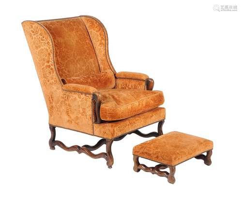 A walnut and cut velvet upholstered wing armchair in the Continental 18th Century style