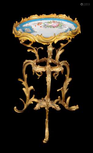 A French assembled porcelain and gilt-metal tripod occasional table in the rococo manner