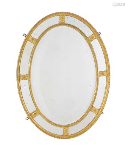 A carved giltwood oval marginal wall mirror