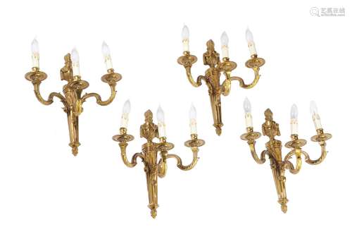 A set of eight gilt metal three light wall appliques in Louis XVI taste