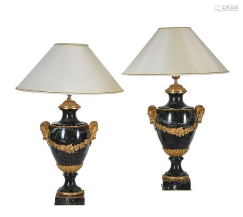 A pair of French green serpentine marble and gilt metal mounted table lamps in Louis XVI style