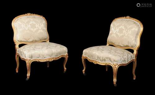 A pair of French carved giltwood low chairs in Louis XV style