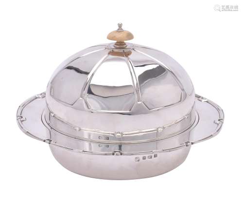 An Art Deco silver circular muffin dish, liner and cover by Northern Goldsmiths Co.