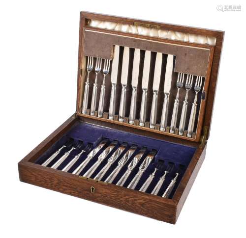 A set of twelve silver fruit knives and forks by Tessiers Ltd