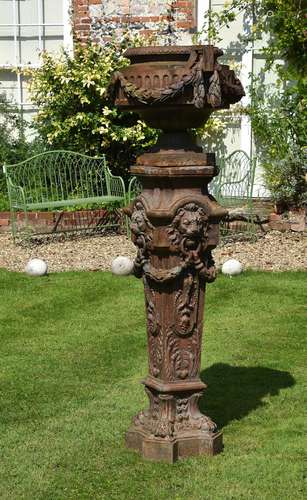 A French cast iron urn on plinth