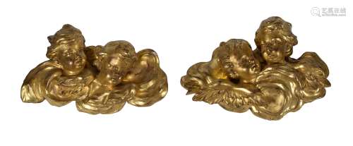 A pair of carved giltwood and gesso groups of cherubs