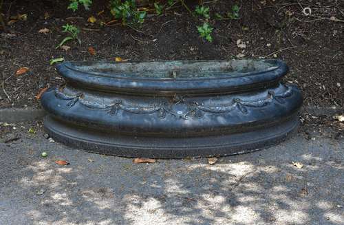 A patinated metal basin or jardiniere