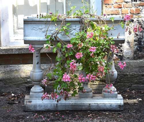 A white painted reconstituted stone planter in the 17th century taste