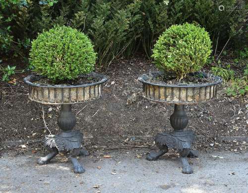 A pair of black painted cast iron planters in late 18th Century style