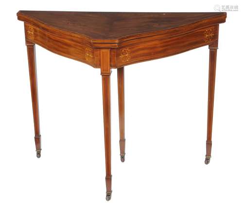 An Edwardian mahogany and marquetry shaped triangular card table