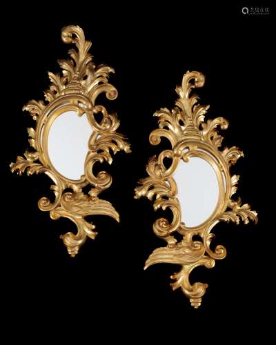 A pair of carved giltwood wall mirrors in the Rococo taste