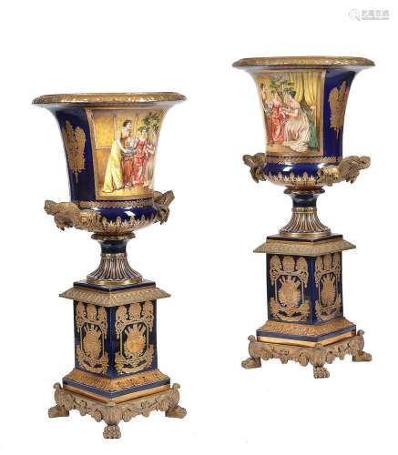 A pair of modern Sevres-style porcelain and gilt metal mounted campana urns and stands