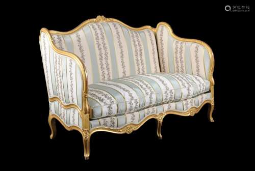 A French carved giltwood sofa in Louis XV style