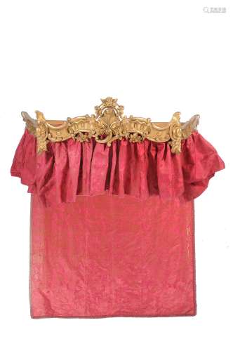 An early 19th century carved giltwood bed canopy