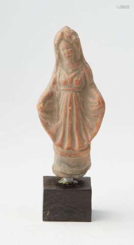 Terracotta statuette representing a woman covered …