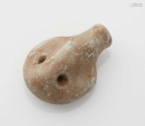 Stone amulet representing a stylized animal head. …