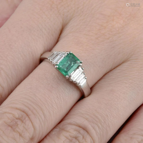 An 18ct gold emerald ring, with baguette-cut diam…