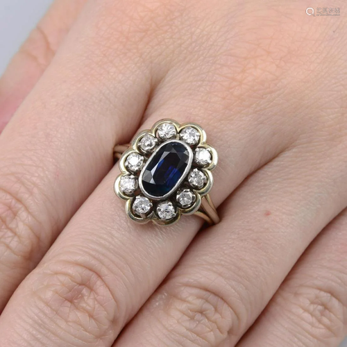 A sapphire and old-cut diamond cluster ring.Sapphire