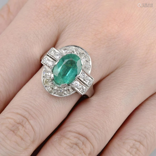 An emerald and old-cut diamond cluster ring.Emerald