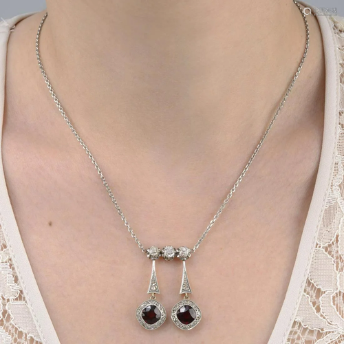 A vari-cut diamond and garnet negligee pendant