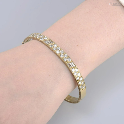 A vari-cut diamond hinged bangle.Estimated total