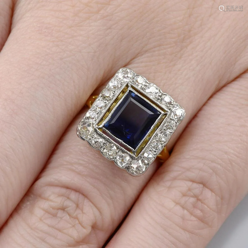 A sapphire and old-cut diamond cluster ring.Sapphire