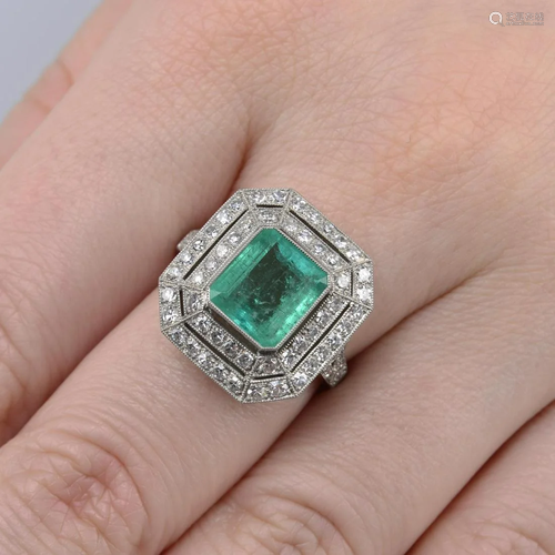 An emerald and single-cut diamond cluster ring. Em…