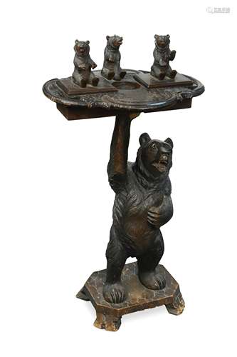 A Black Forest carved bear smoker's stand,