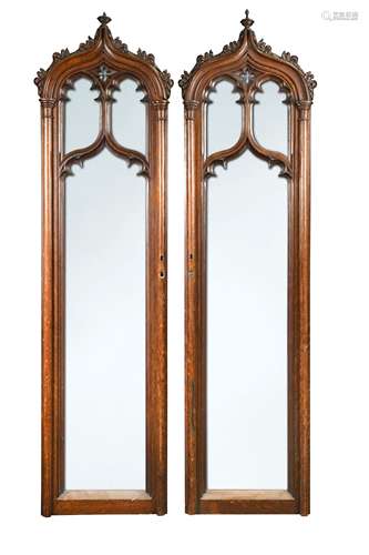 A pair of carved oak Gothic revivial arched door panels,