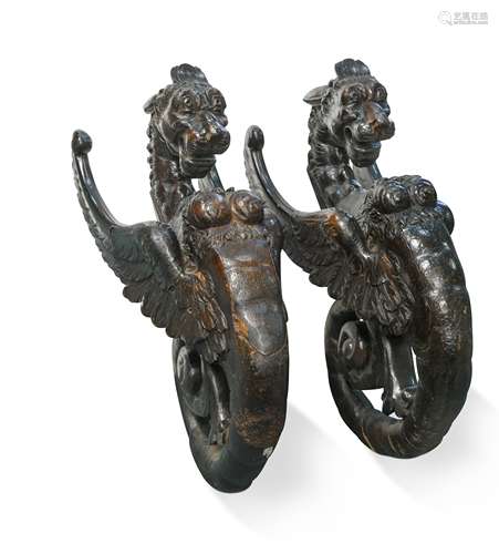 A pair of late 16th or early 17th century carved gryphon-type mounts,