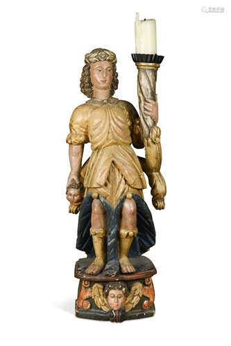 A carved and polychrome decorated limewood figure of a torch bearer, 18th century,