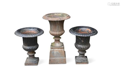 A pair of cast iron Campagna style urns together with associated stands,