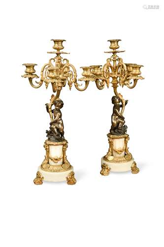 A pair of Louis XV style bronze putto five light candelabra, circa 1900,