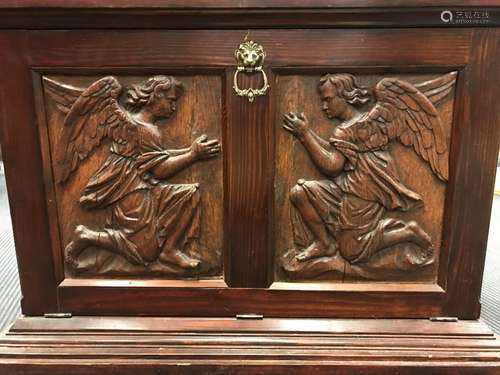 A pair of carved oak panels of kneeling angels,