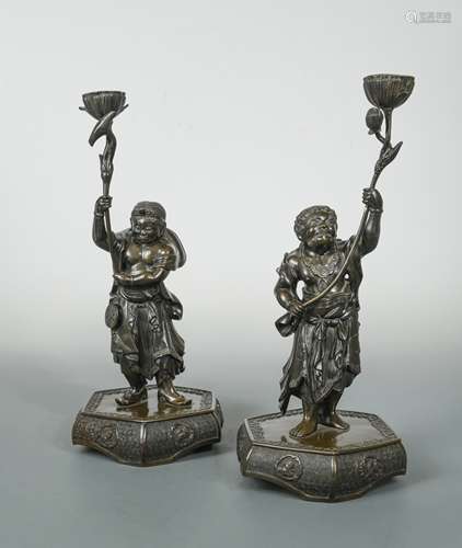 A pair of Chinese bronze figural candle holders, Qing Dynasty late 19th century,