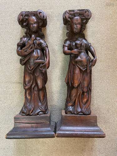 A pair of carved oak caryatids, probably 17th century,