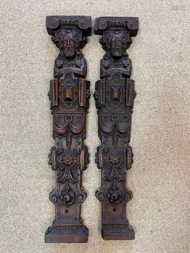 Two similar carved oak herms,