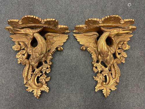 A pair of carved and gilded wood eagle wall brackets,