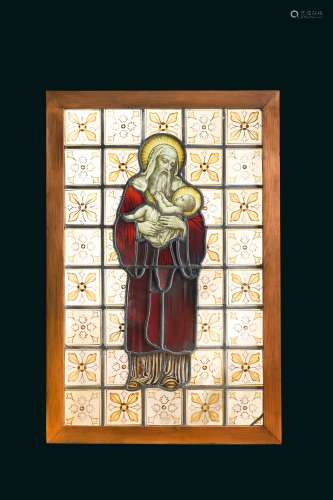 A 19th century stained glass panel of a male saint holding the infant Jesus