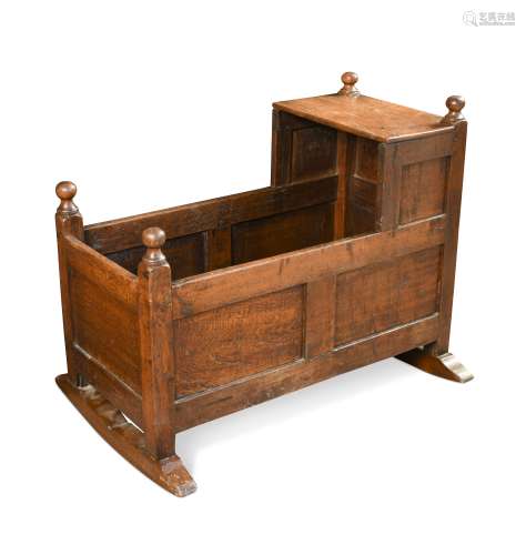 An early 18th century style oak cradle,