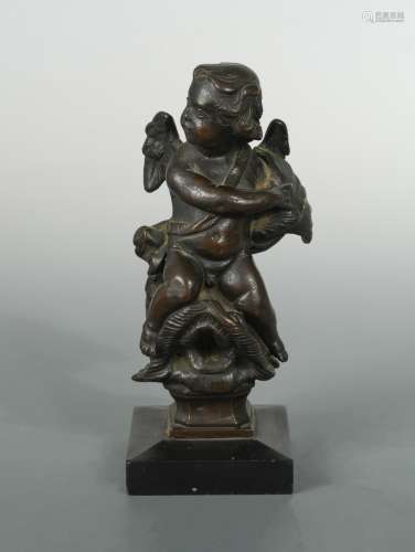 A 17th century bronze model of a cherub,